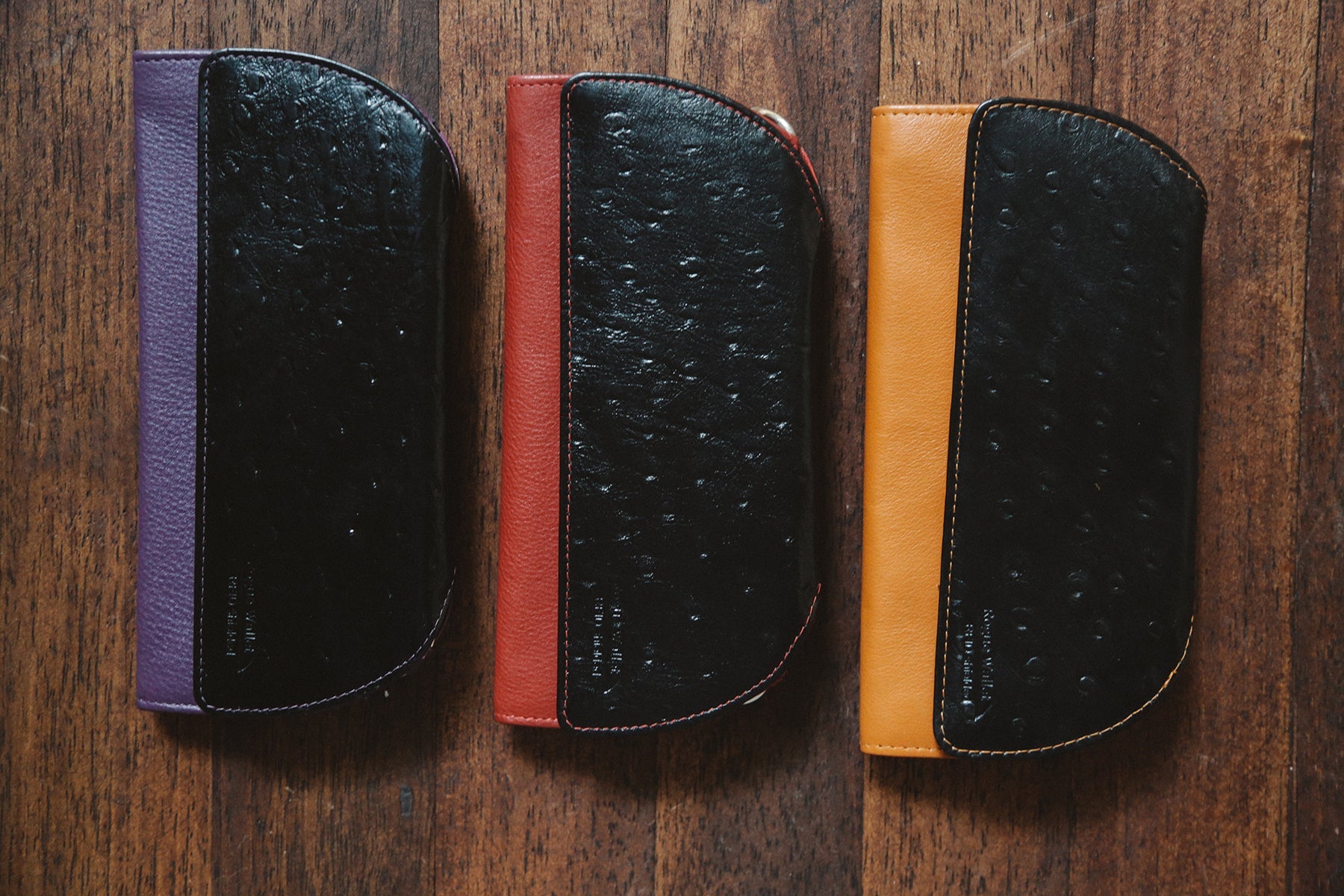 Rogue Industries RFID blocking ostrich print clutches in teal, tan, red, and purple